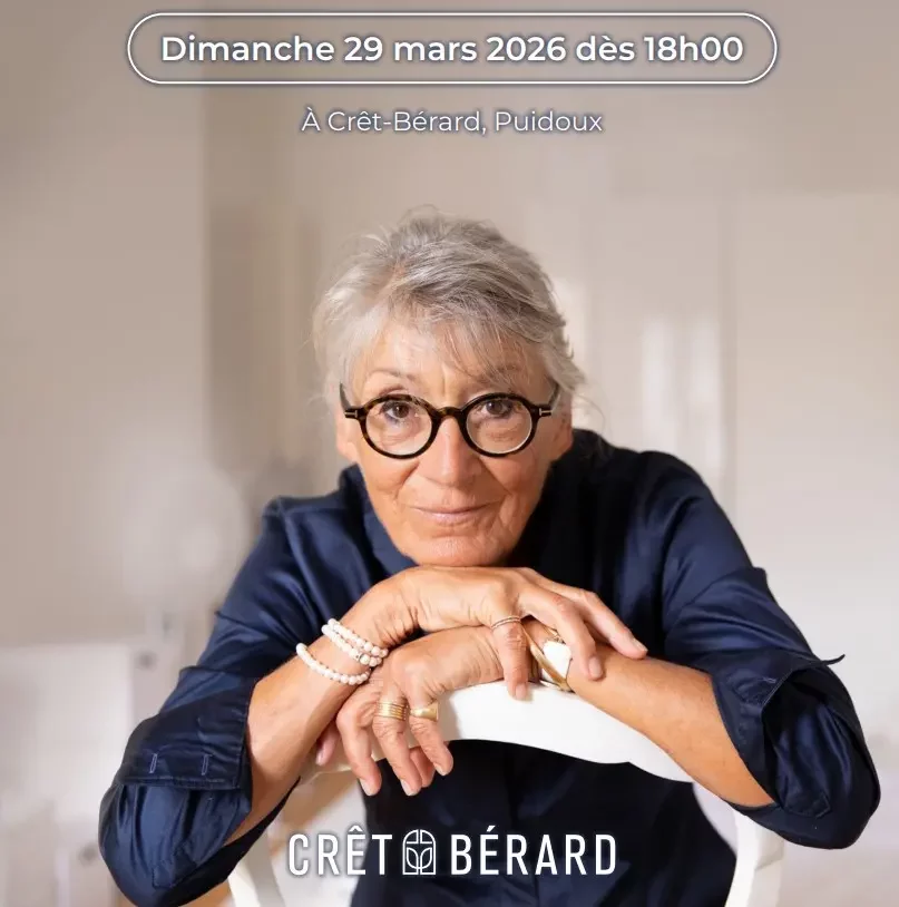 a young boy sitting on top of a large rock